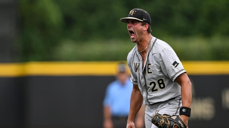 Wake Forest pitcher Cole Roland reacts after striking out Alabama's...