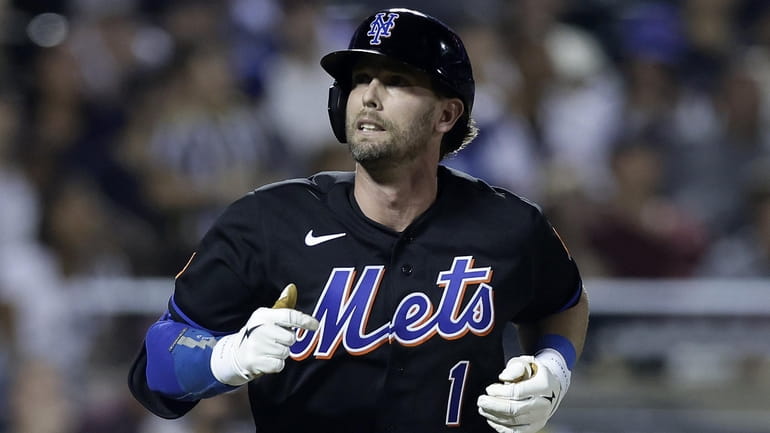 Jeff McNeil of the Mets flies out during the ninth inning...
