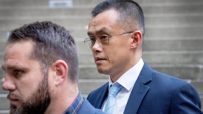 Binance founder and CEO Changpeng Zhao, right, leaves federal court...