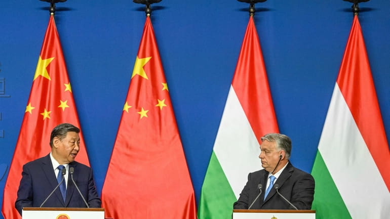 Chinese President Xi Jinping, left, speaks during his joint press...