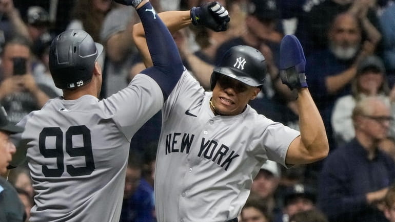 Yankees' Aaron Judge celebrates his two-run home run with Juan...