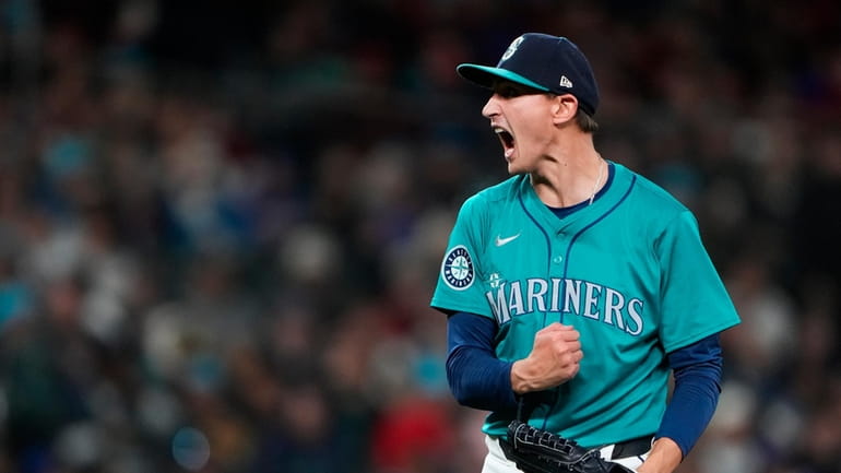 Seattle Mariners starting pitcher George Kirby reacts after striking out...