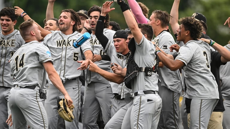 Wake Forest celebrates after winning an NCAA college baseball tournament...