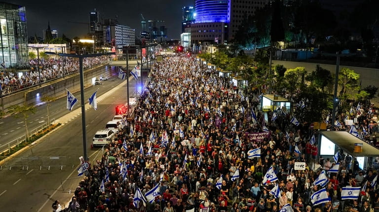 People protest against Israeli Prime Minister Benjamin Netanyahu's government and...