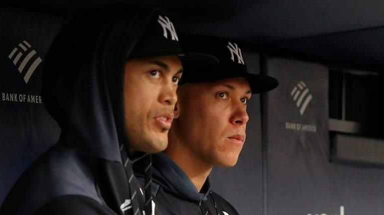 Giancarlo Stanton and Aaron Judge of the Yankees looks on from...