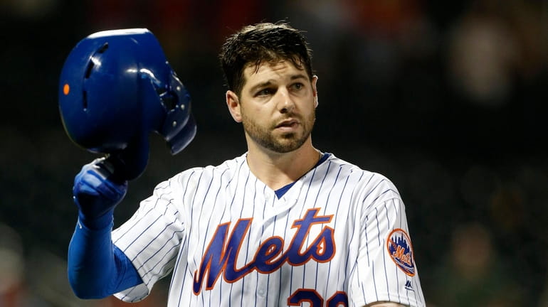 Kevin Plawecki #26 of the Mets reacts after flying out...