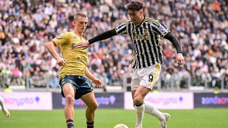 Juventus' Dusan Vlahovic, right, takes on Genoa's Albert Gudmundsson during...