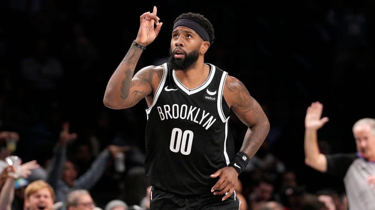 Nets forward Royce O'Neale reacts after making a three-point basket against...
