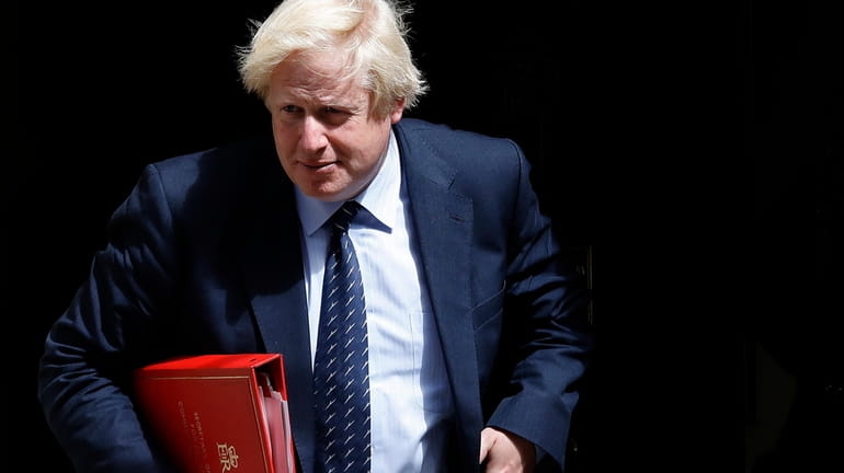 Britain's Foreign Secretary Boris Johnson leaves a cabinet meeting at...