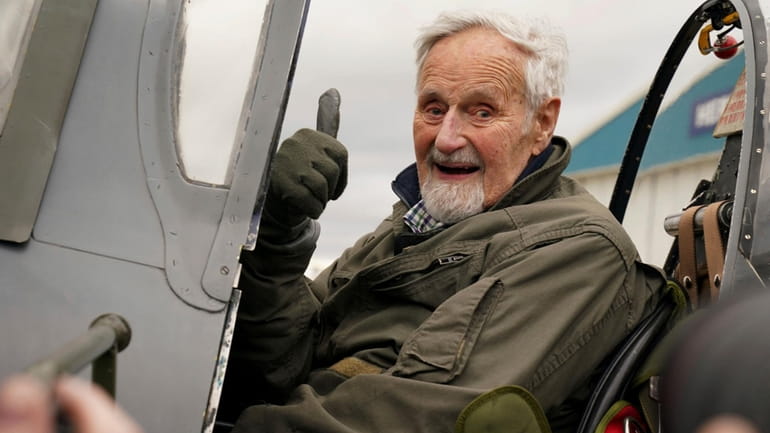 102-year-old Jack Hemmings AFC gestures after flying a Spitfire plane...