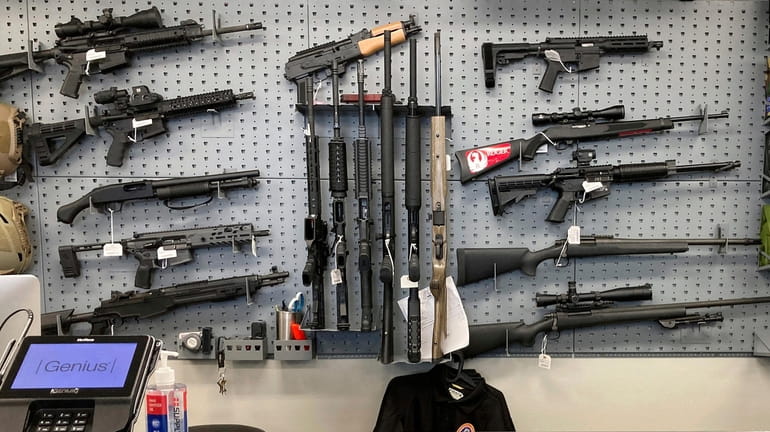 Firearms are displayed at a gun shop in Salem, Ore.,...