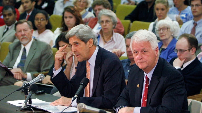 Sen. John Kerry, center, D-Mass., speaks alongside U.S. Rep. William...