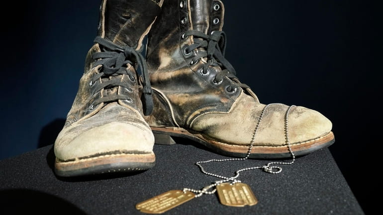 Combat boots and dog tags worn by Alan Alda as...