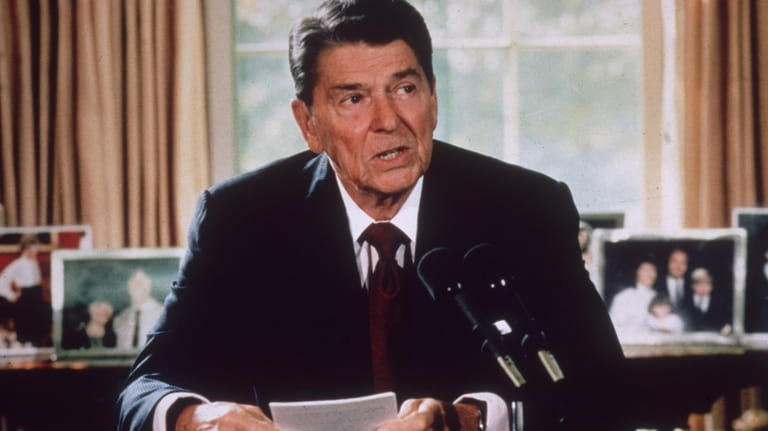  Ronald Reagan makes an announcement from his desk at the...