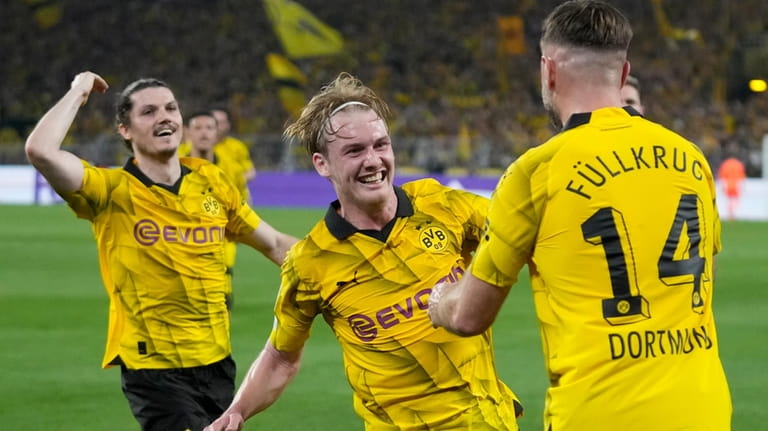 Dortmund's Niclas Fuellkrug, right, celebrates after scoring his side's opening...