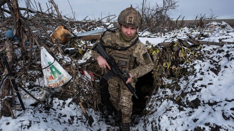 A Ukrainian soldier takes his position on the frontline near...