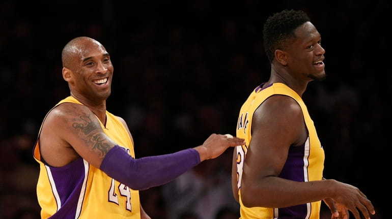 Kobe Bryant, left, celebrates with Julius Randle, right, during the...
