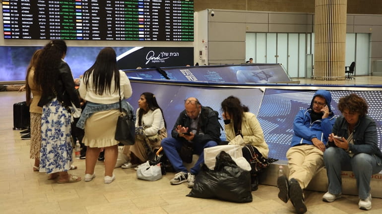 Passengers wait at Ben Gurion Airport near Tel Aviv on...