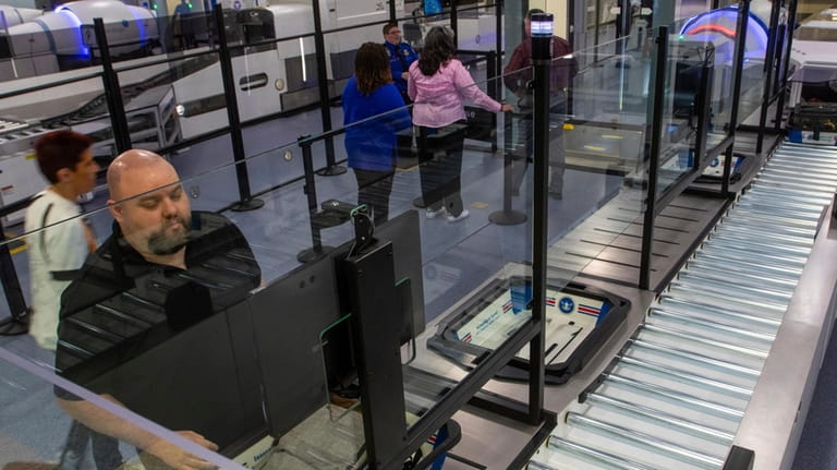 A TSA official demonstrates new screening equipment at Harry Reid...