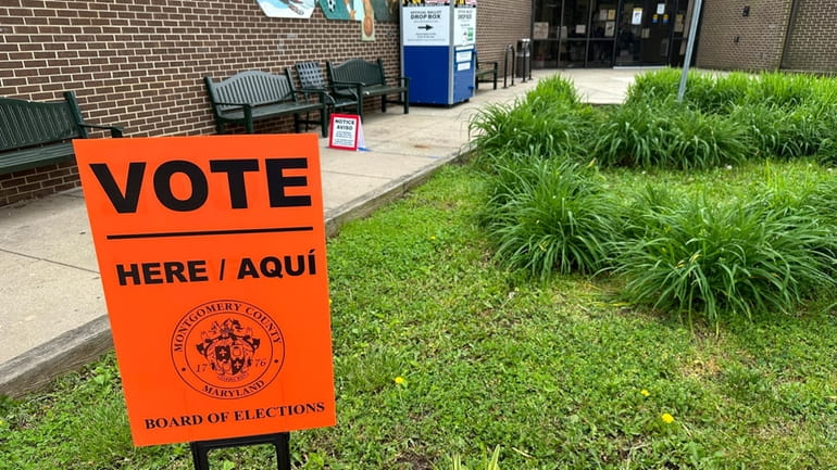 Signs are pictured outside an early voting center on Thursday,...