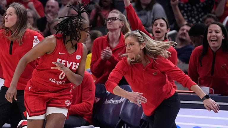 Indiana Fever coach Christie Sides celebrates a 3-point shot by...