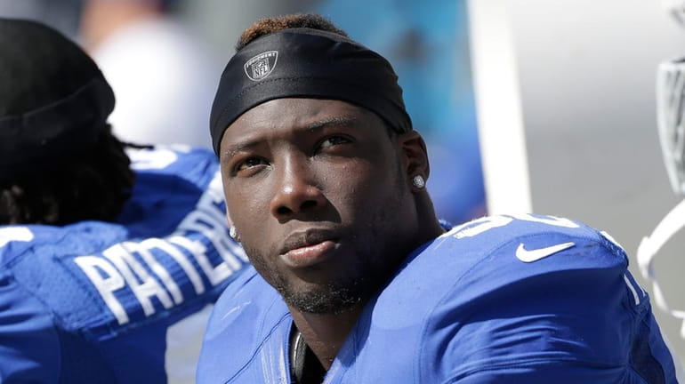 The Giants' Jason Pierre-Paul sits on the sidelines against the...