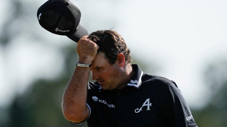 Patrick Reed reacts after missing a putt on the 18th...
