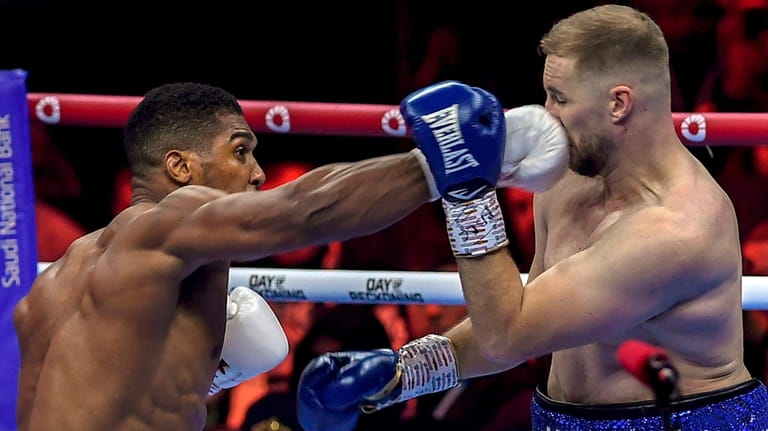 Anthony Joshua, left, and Otto Wallin fight during a boxing...