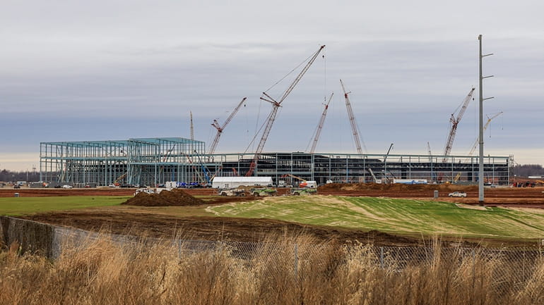 Construction continues on the first of two manufacturing plants as...