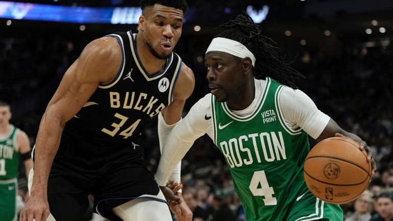 Boston Celtics' Jrue Holiday gets past Milwaukee Bucks' Giannis Antetokounmpo...