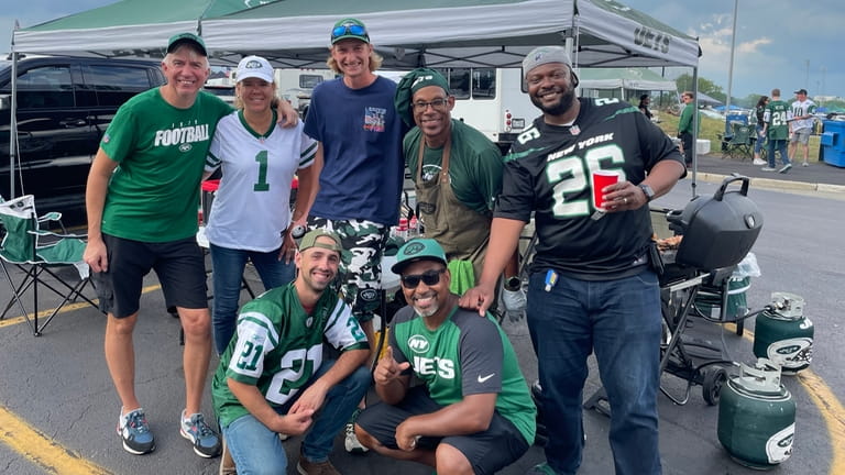 Mikel Pierre (right, #26) with his fellow Jets tailgaters before...