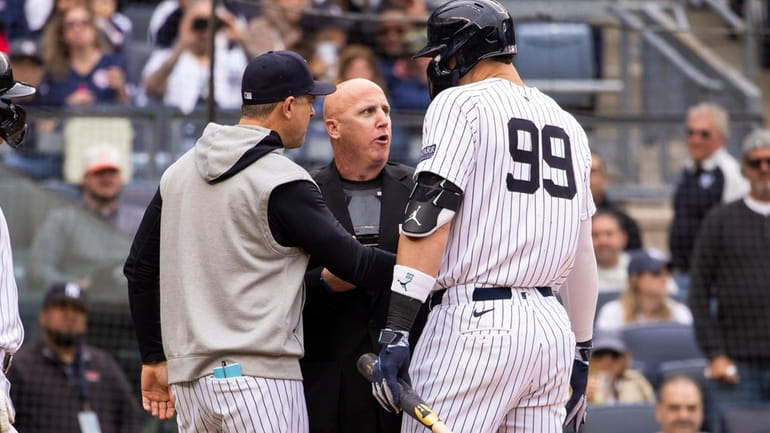 New York Yankees manager Arron Boone, left, argues with the...