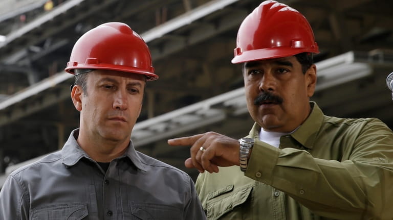 Venezuela's President Nicolas Maduro and Vice President Tareck El Aissami,...