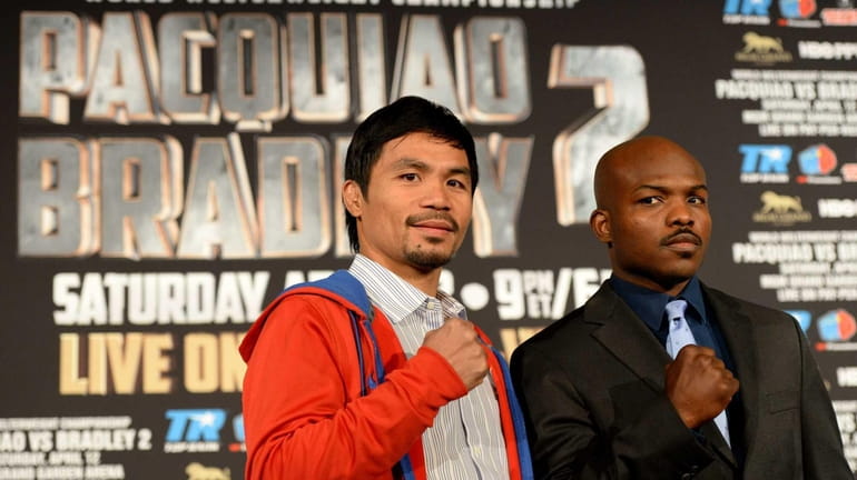 Filipino boxer Manny Pacquiao (L) and Timothy Bradley of the...