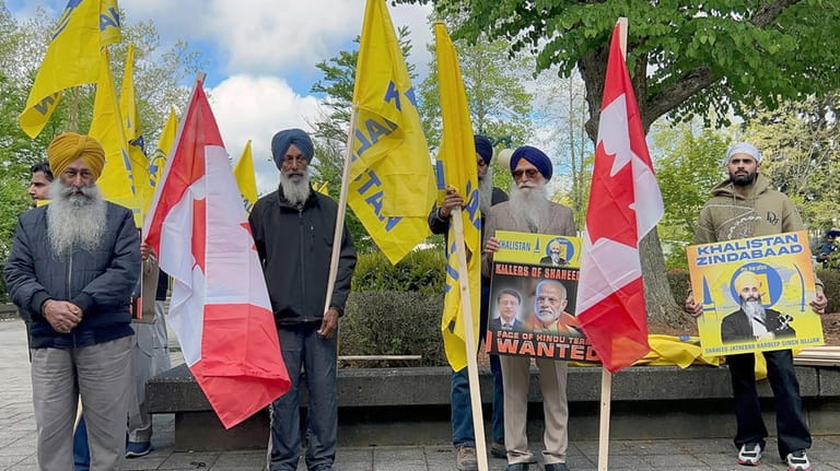 Members of British Columbia's Sikh community gather in front of...
