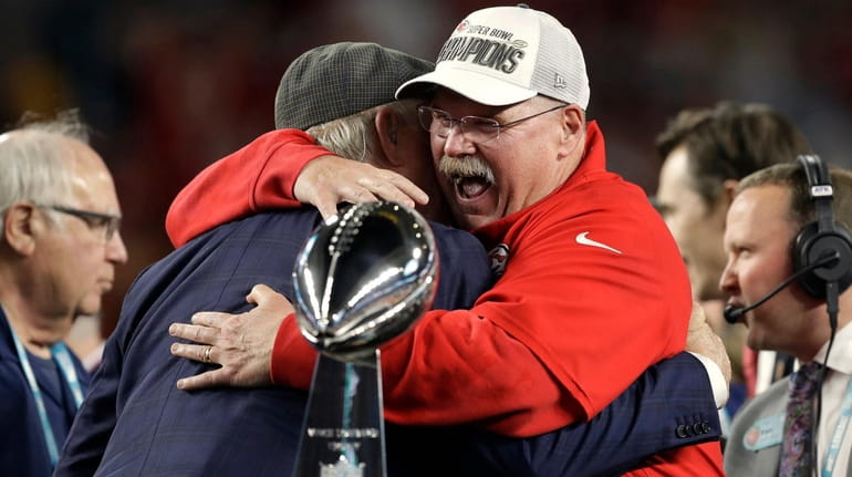 Chiefs head coach Andy Reid receives congratulations from broadcaster Terry...