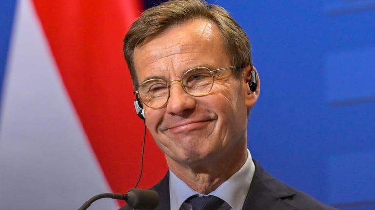 Sweden's Prime Minister Ulf Kristersson smiles during a press conference...