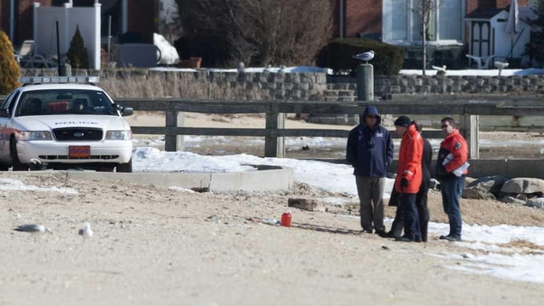 Officials gather around medical waste found on Manorhaven Beach Park...