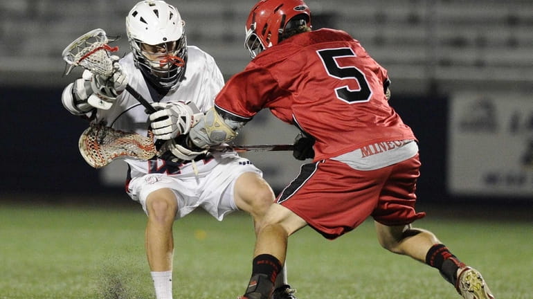 Cold Spring Harbor attacker Ryan Winkoff is checked by Mineola...