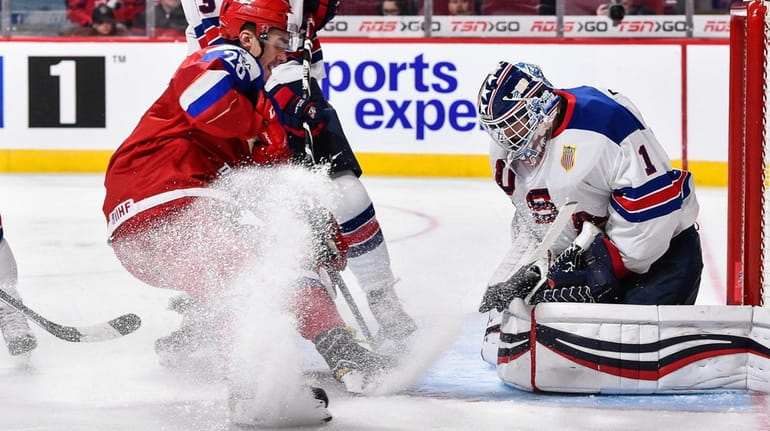 U.S. goaltender Tyler Parsons makes a save in front of...