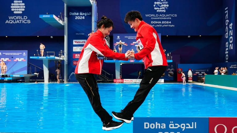 Yani Chang and Yiwen Chen of China celebrate after winning...