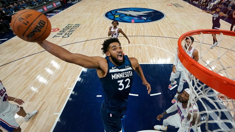 Minnesota Timberwolves center Karl-Anthony Towns (32) goes up for a...