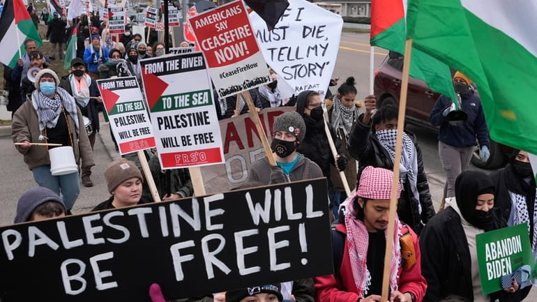 Pro-Palestinian demonstrators march during a visit by President Joe Biden...