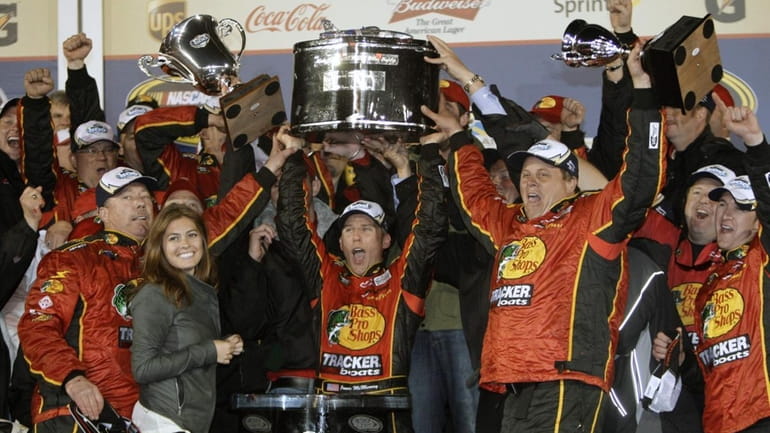 Jamie McMurray, center, with crew, celebrates in victory lane after...