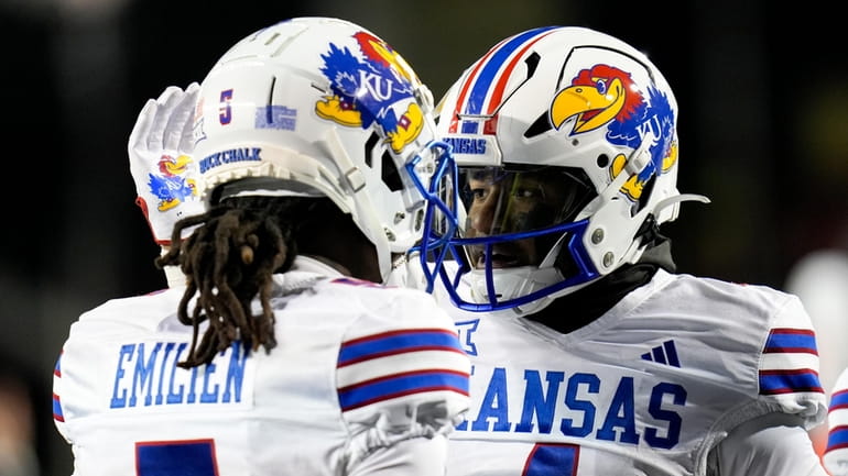 Kansas running back Devin Neal, right, pats wide receiver Doug...