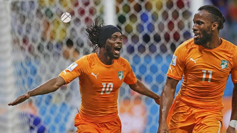 Ivory Coast's Gervinho celebrates with teammate Didier Drogba after Gervinho...