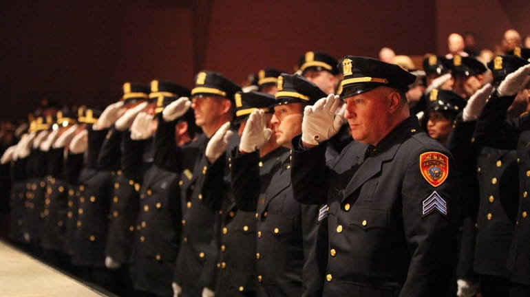 Suffolk County Police Department cops salute during a SCPD promotion...