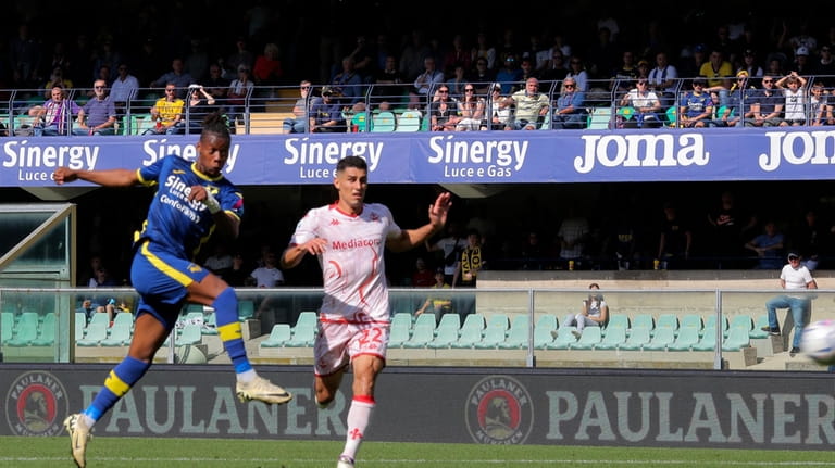 Verona's Tijjani Noslin, left, scores his side's second goal during...
