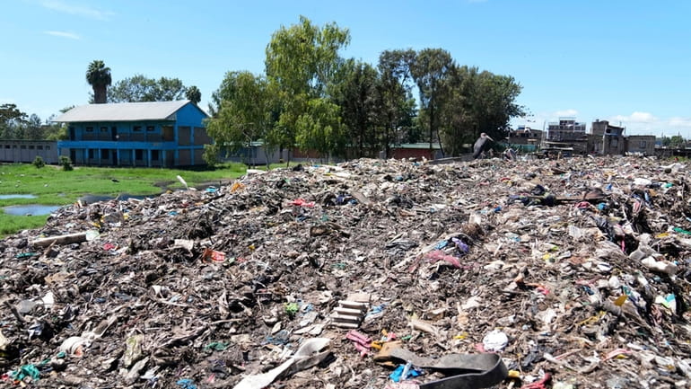 The Dandora Secondary school, separated with a mountain of garbage...
