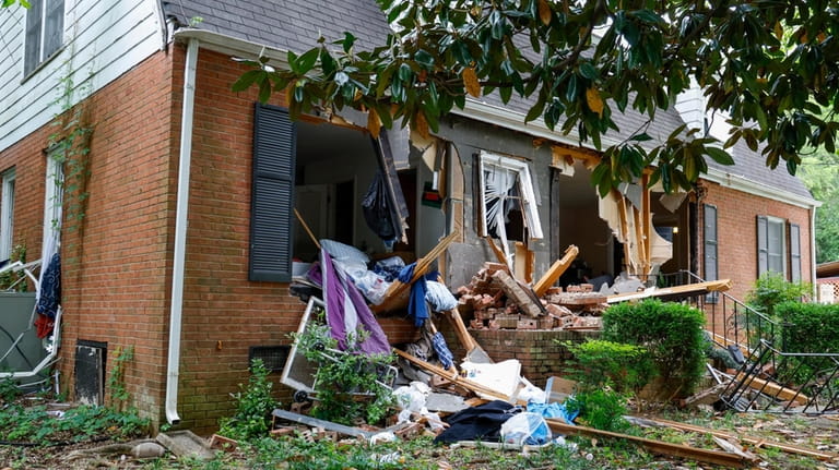 Debris surrounds a home, Tuesday, April 30, 2024, where a...